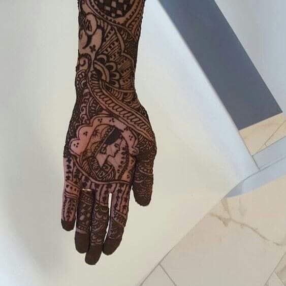Detailed bridal henna art on the hand and arm